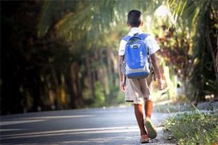 student walking down sidewalk